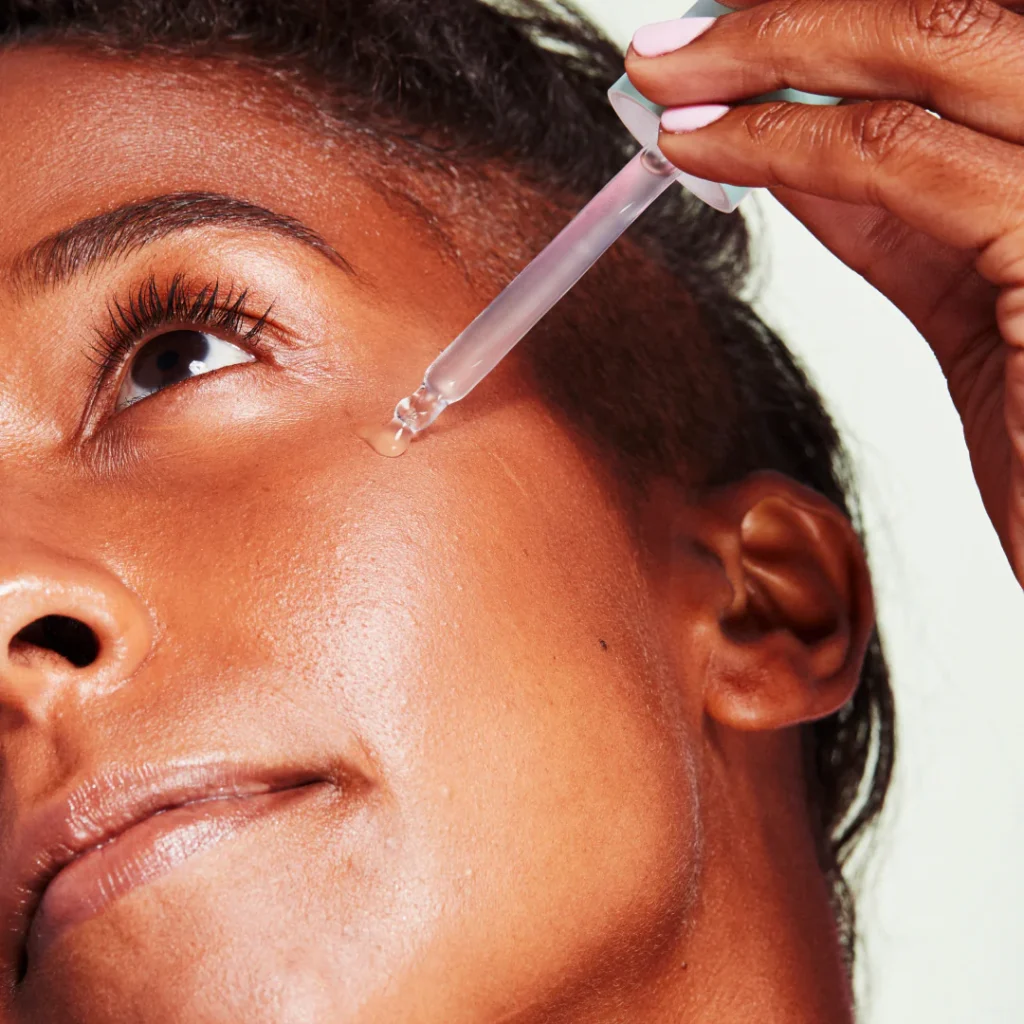 a woman using a serum